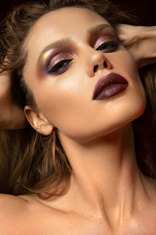Beautiful woman with red make up and red light