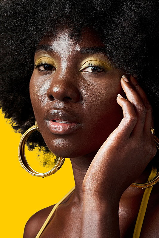Fashion, face makeup and creative black woman with designer power against a mockup studio backgroun.